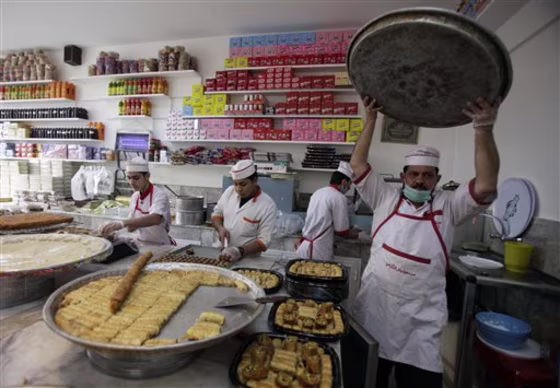 An Iraqi baker prepares sweets in Baghdad, Friday, July 29, in preparation for the Muslim fasting month of Ramadan, which is set to begin on August 1.